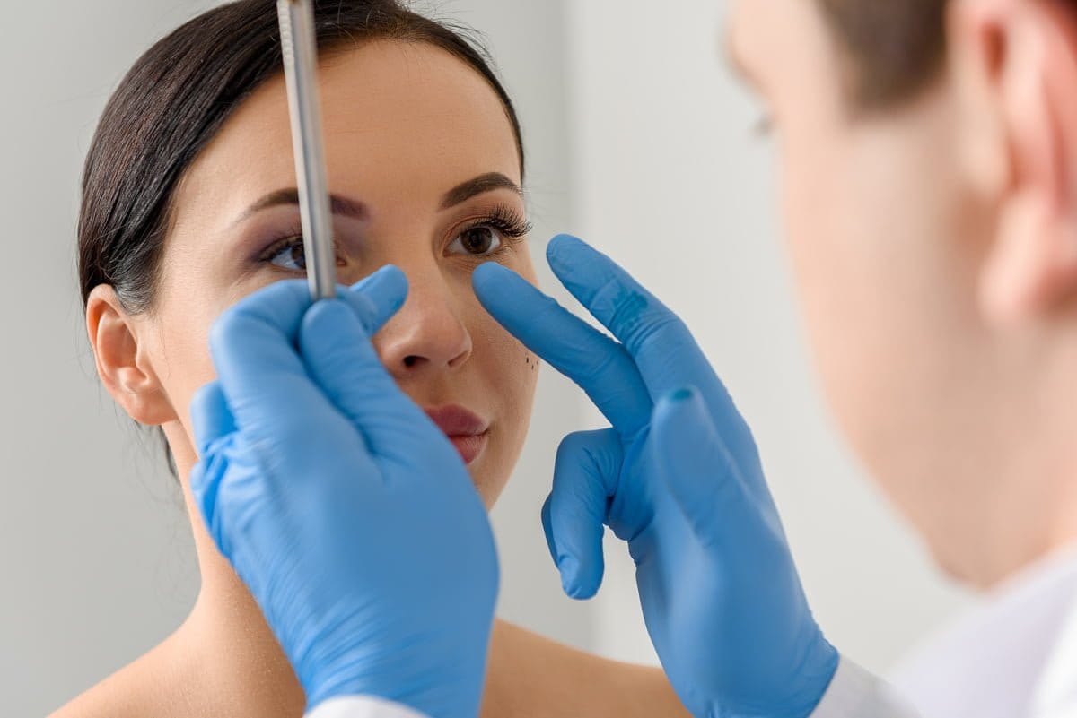 Woman in a Cosmetic Surgery Consultation for Rhinoplasty Revision