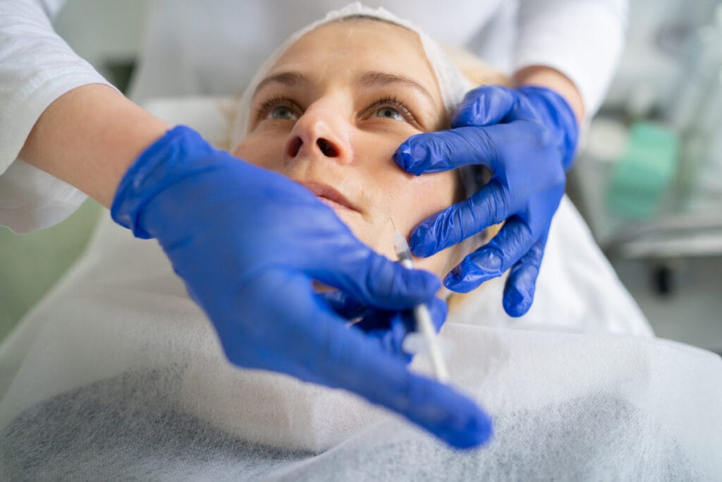 Woman getting filler injections for smile lines and nasolabial folds