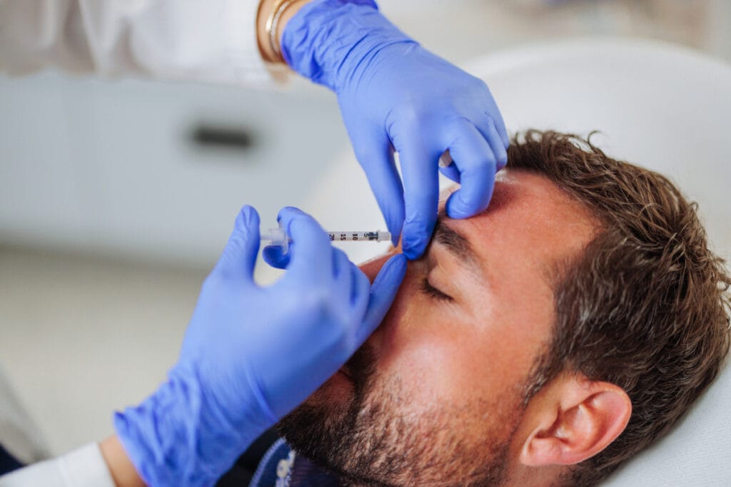 Man getting Botox injections in the forehead